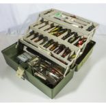 A fishing tackle box and contents including lures and flies
