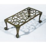 A cast brass trivet