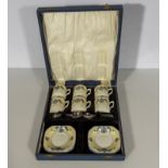 A cased set of six coffee cans and saucers