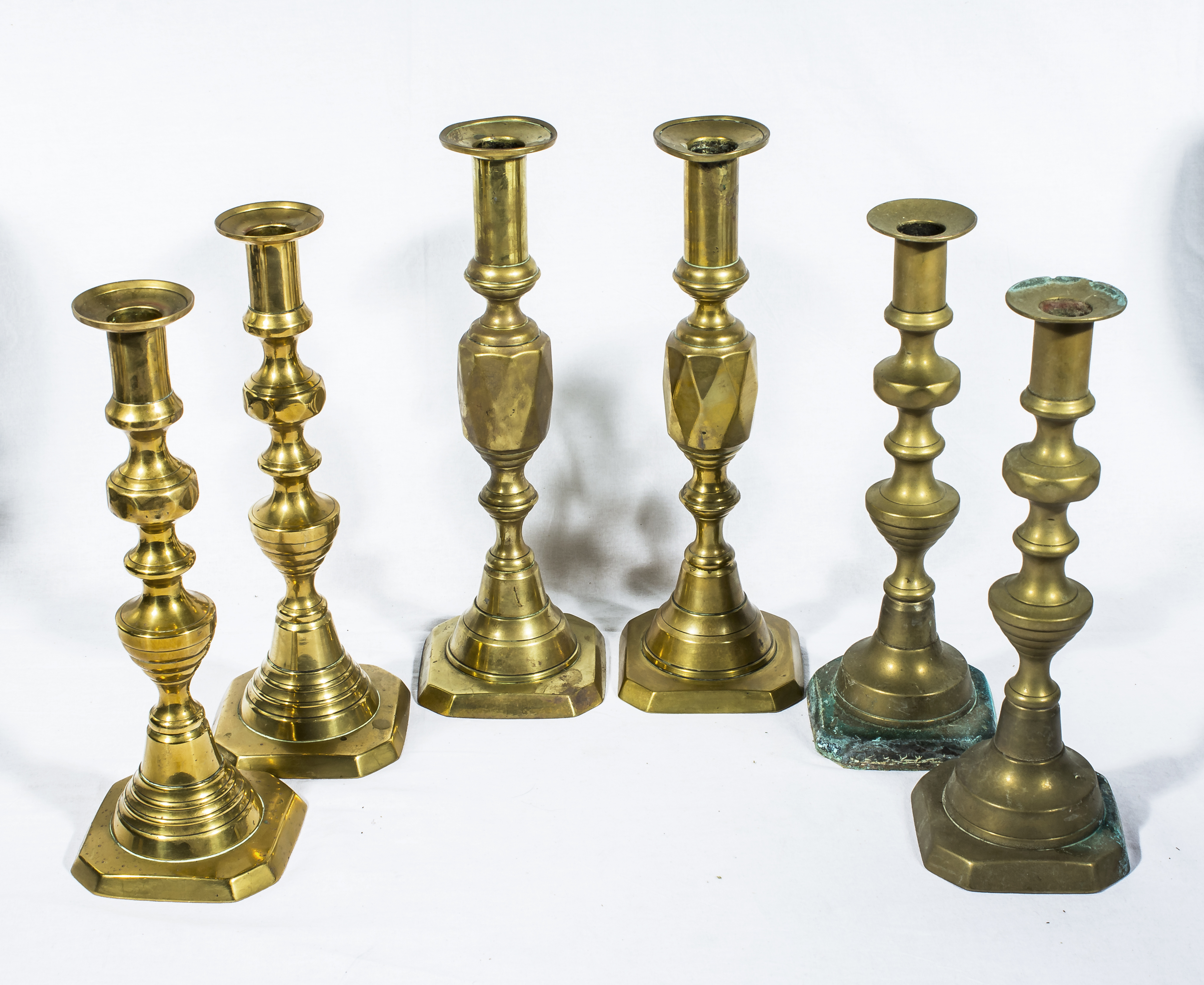 Three pairs of brass candlesticks