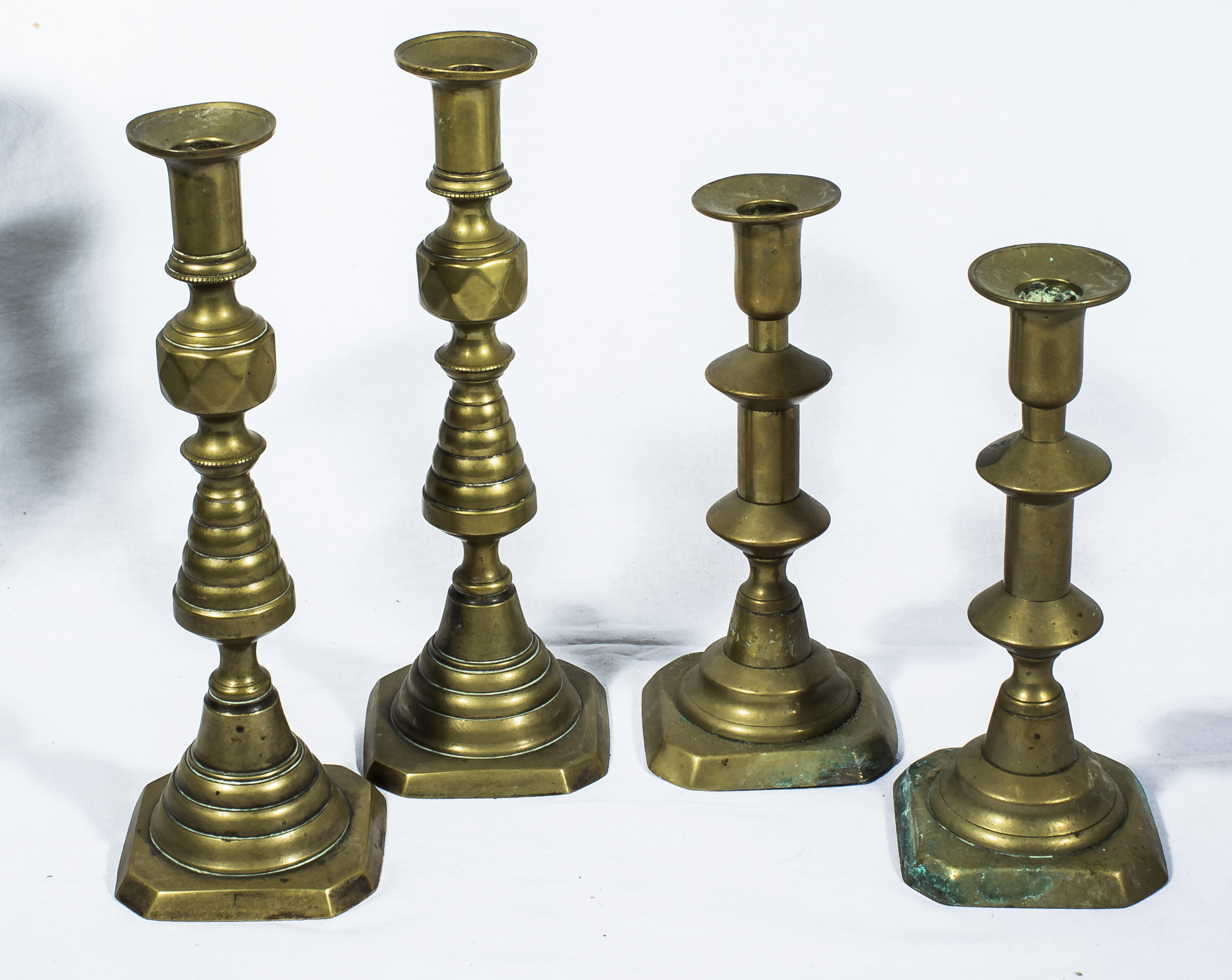 Two pairs of brass candlesticks