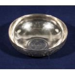 An Arabic silver dish with coin inset