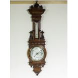 An impressive Victorian carved oak barometer.