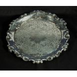 A silver salver on four feet, 466gms marks for London 1899 Thomas Smith & Sons, George Street,