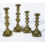 Two pairs of brass candlesticks