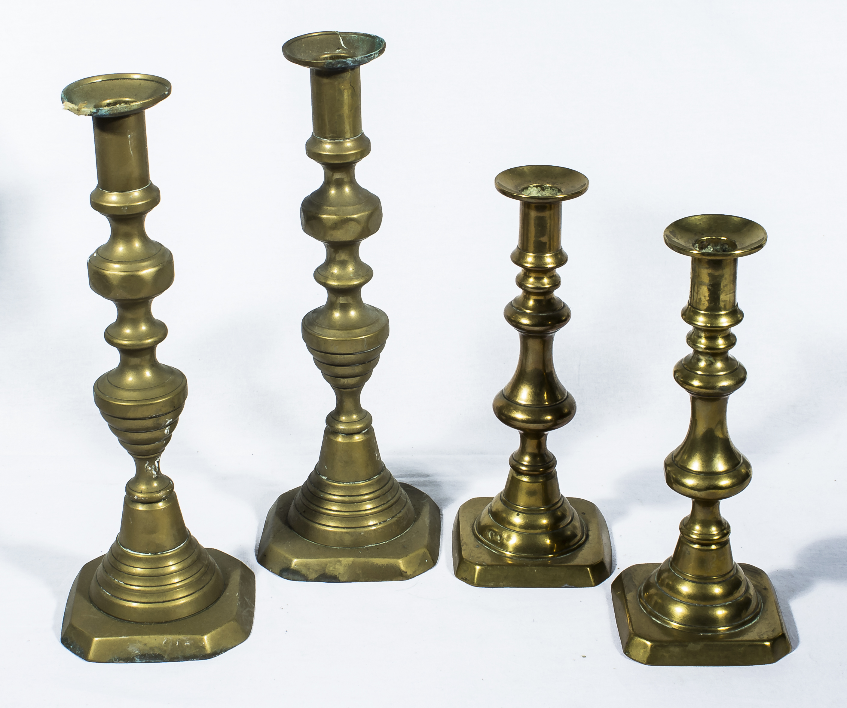 Two pairs of brass candlesticks