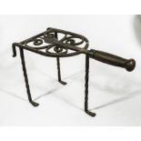 A wrought iron range trivet