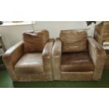 A pair of leather armchairs