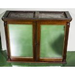 A two door glazed Victorian campaign cabinet with carrying handles.