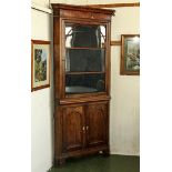 A late Georgian oak double corner cabinet.