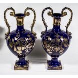 A pair of blue ground with gilt decoration urns 44cm high