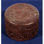 A circular lidded cinnabar box