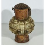 A copper and glass ships lamp