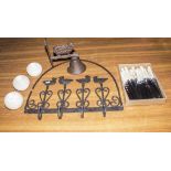 A metal bell, coat hook, cutlery and candle holders