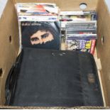 A box containing records and CD's