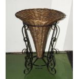 A wicker basket in wrought iron frame