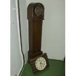 A grandmother clock case together with a modern wall clock