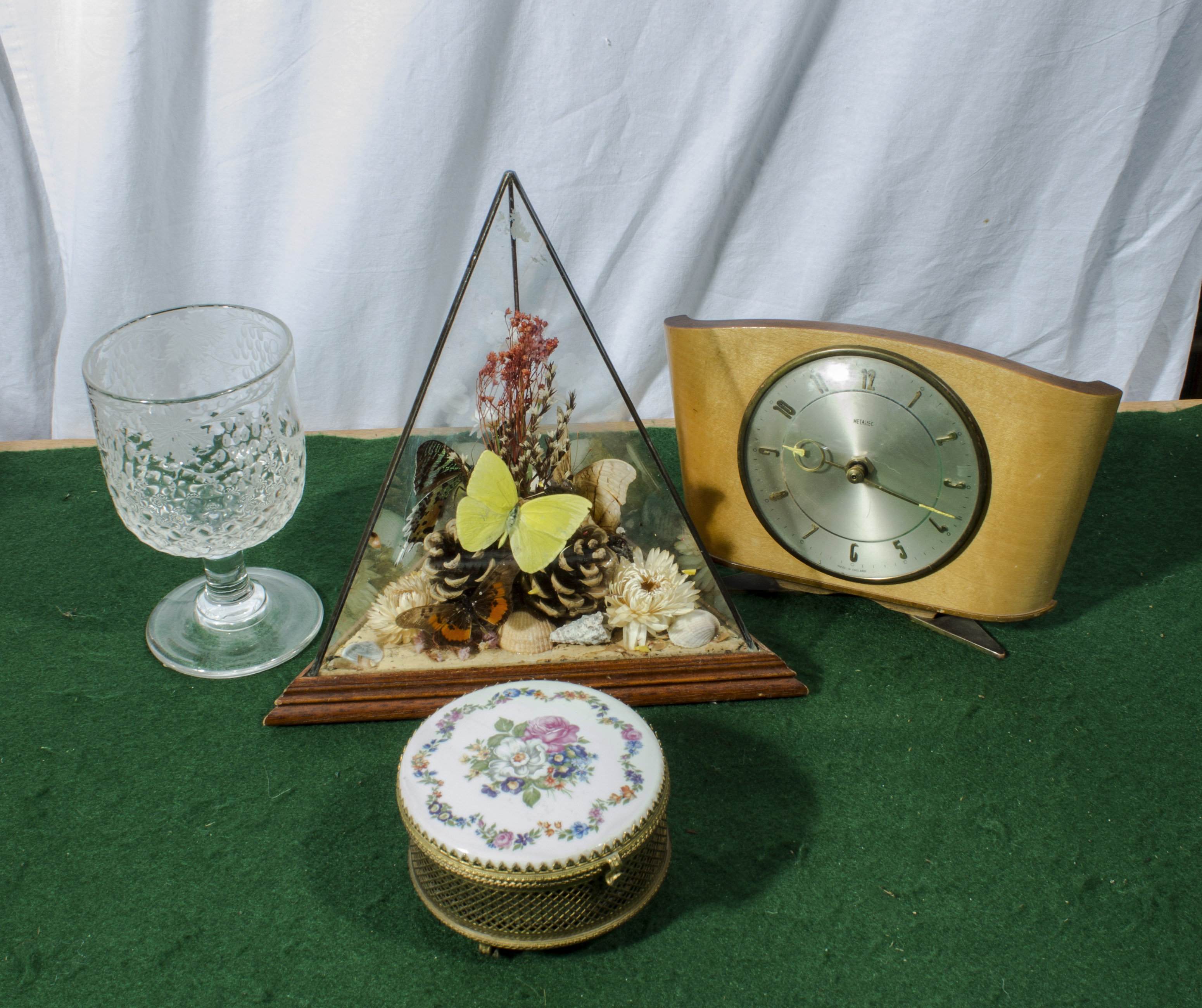 A terrarium, goblet, clock and an enamel lidded box