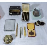 A cigarette case, pens and other items