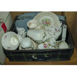 A suitcase containing pottery and china