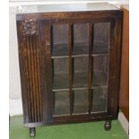 A small oak glass fronted cabinet