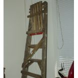 A pair of step ladders and a coat rack