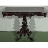 A Victorian mahogany shaped top tea table on finely carved centre column terminating on cabriole