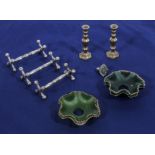 Three knife rests, two miniature candlesticks. a ring and 4 glass shades