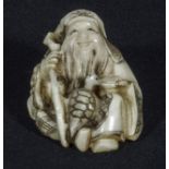 A Japanese ivory netsuke, man with staff and turtle, signed