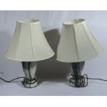 A pair of marble based table lamps with shades