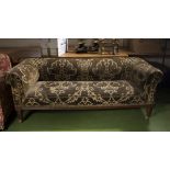 A Victorian low backed upholstered sofa