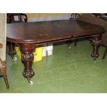 A Victorian mahogany wind out table