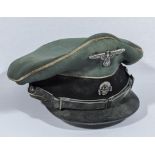 A WWII German SS officers cap with black leather chin strap