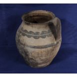 A medieval pottery decorated jug with wash decoration,