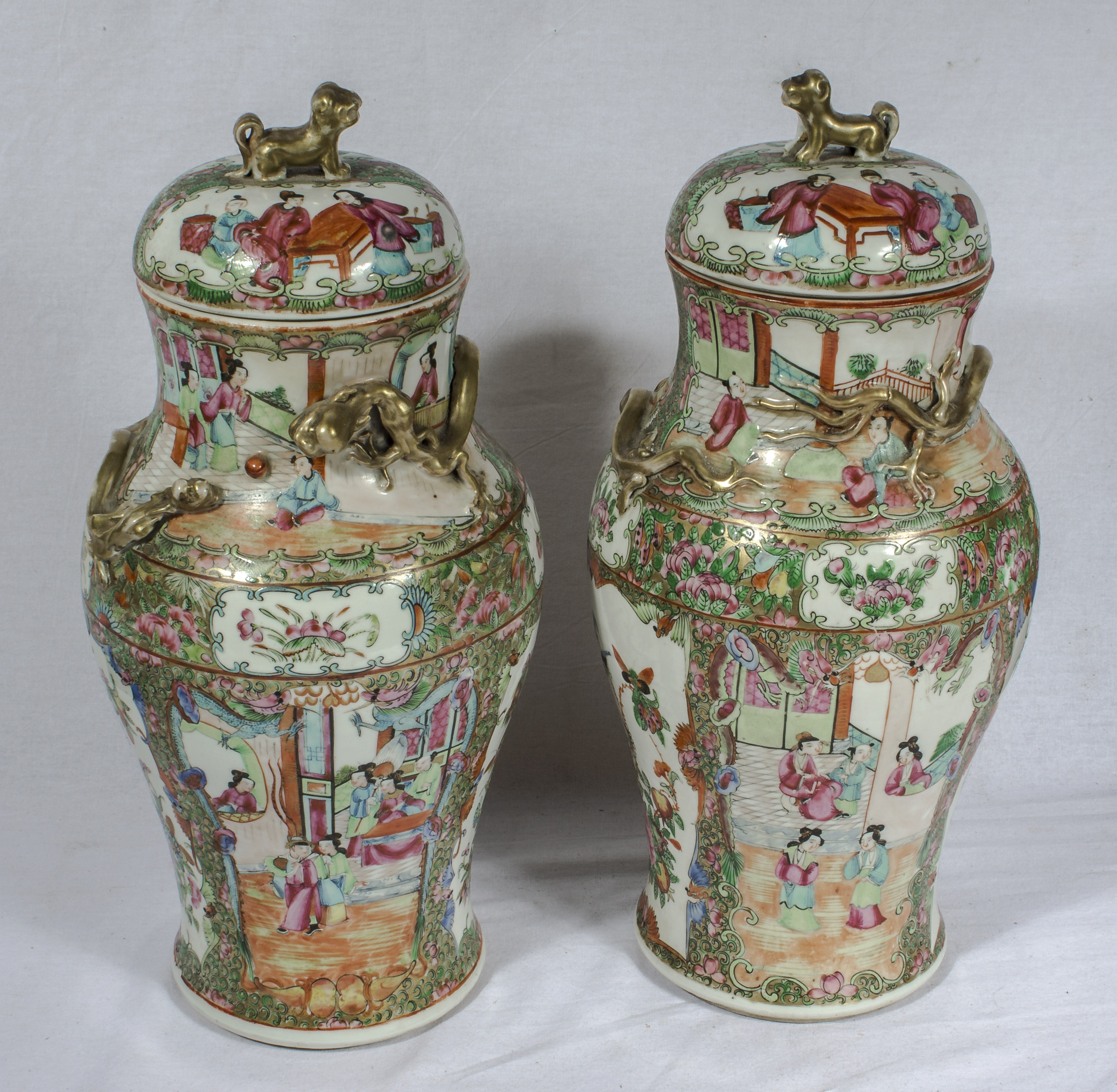 A pair of Chinese Qing period Canton famille rose lidded vases, 39cm tall