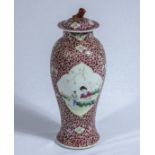 A famille rose lidded vase, crack to body, 28cm tall