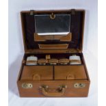 A brown leather dressing case and fittings