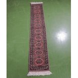 A hand woven woolen Uzbek Bokhara runner, 31cm x 170cm