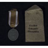 A German West Wall medal and paper envelope