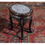 A Chinese hardwood stand with mother of pearl inlay and marble insert