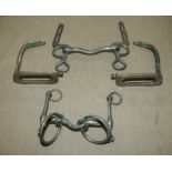 A pair of stirrups and two horse bits