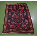 A hand woven wool Balochi rug, 84cm x 124cm