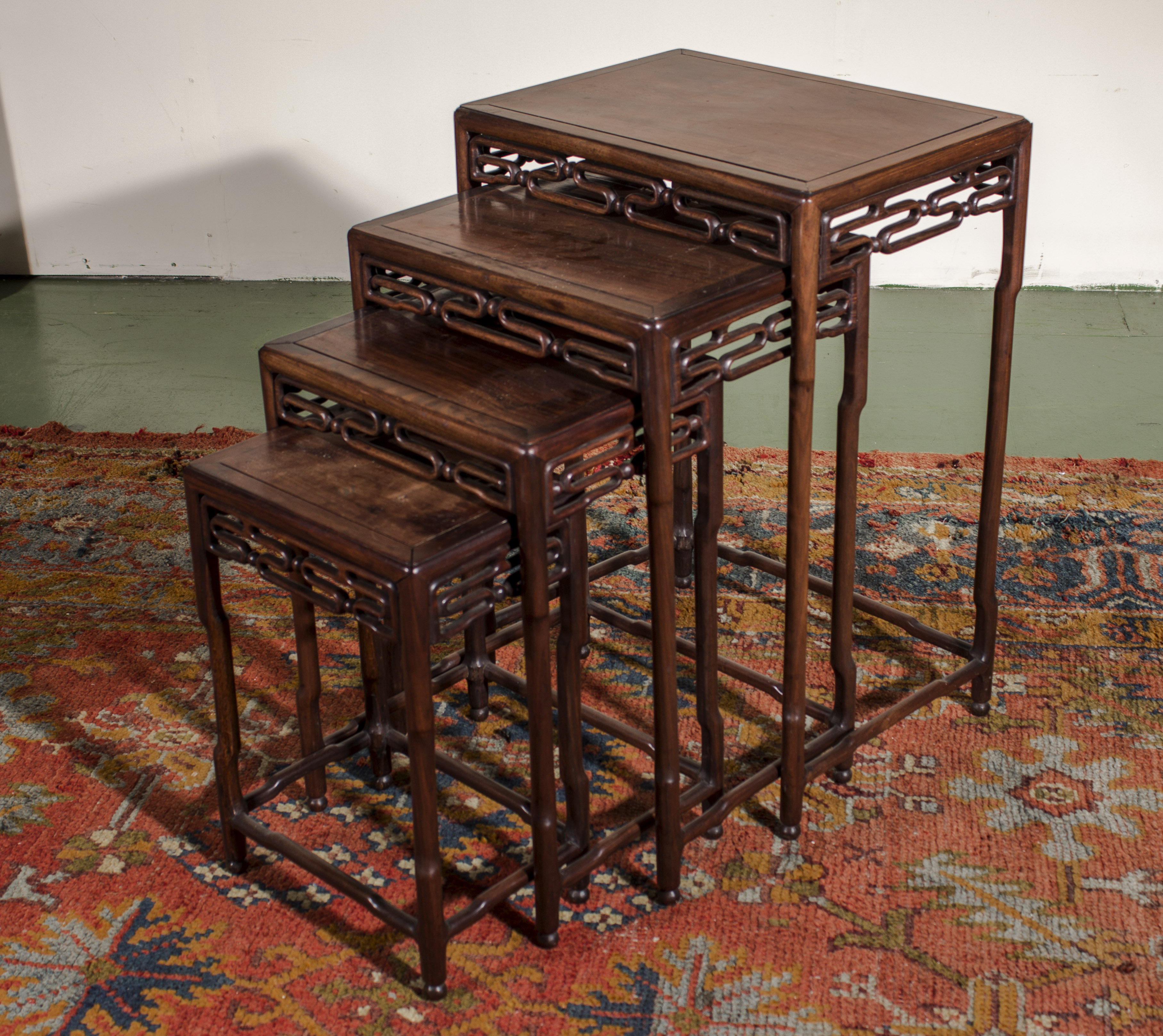 A Chinese hardwood nest of four tables