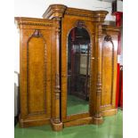 A high quality Victorian walnut breakfront fitted wardrobe, with mirror centre door flanked by panel