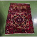 A hand woven wool Balochi rug, 84cm x 130cm