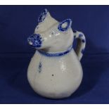 A saltglazed jug in the form of a pig with blue decorated highlights, 23cm tall