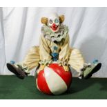 A large terracotta clown with a ball, signed and dated