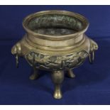 A Chinese tripod base censer cast with animal head handles and character marks to base, 14cm tall