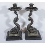 A pair of mixed metal serpent candlesticks