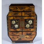 A small Oriental mixed wood cabinet with black lacquer interior, opening to top reveals fitted